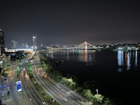 a view of a city at night with a bridge